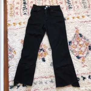 Sandro Paris jeans w/ floral accents at the bottom of each leg. Kind of flared.